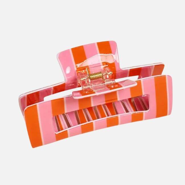19 Fresh FINDS Around BHAM: Closet Refreshers, Entertaining Picks & More - 20 A Birmingham FINDS April highlight: a rectangular hair claw clip with alternating pink and red vertical stripes, featuring a spring hinge and a cutout section in the center.