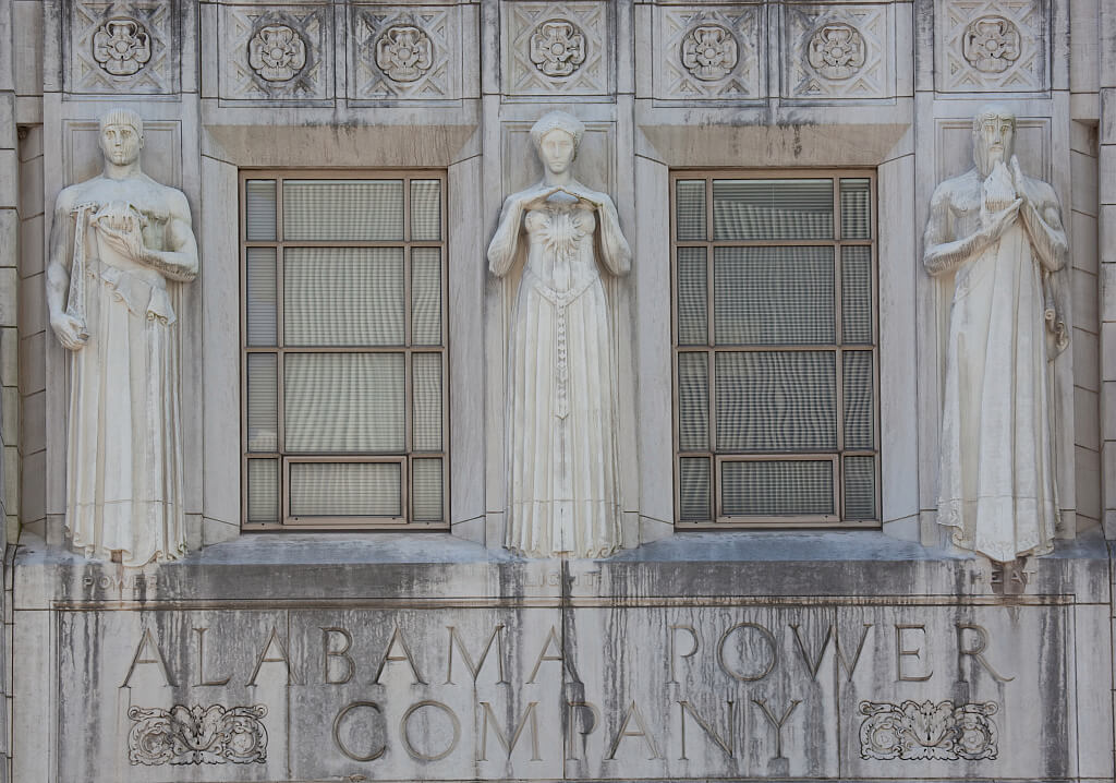 The stone facade of the Alabama Power Company building showcases Birmingham’s Golden Goddess, with three sculpted figures representing power, light, and heat.