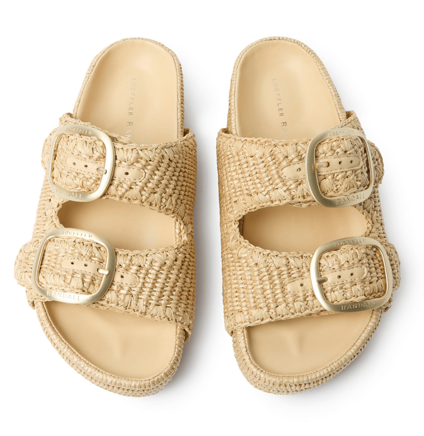 A pair of beige woven sandals from Birmingham FINDS, featuring two large adjustable gold buckles on each sandal, displayed side by side on a white background—perfect for sunny days in May.