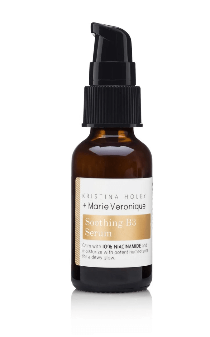 A brown glass bottle of Kristina Holey + Marie Veronique Soothing B3 Serum with a black pump dispenser and white label, perfect for soothing skin in May or any season.
