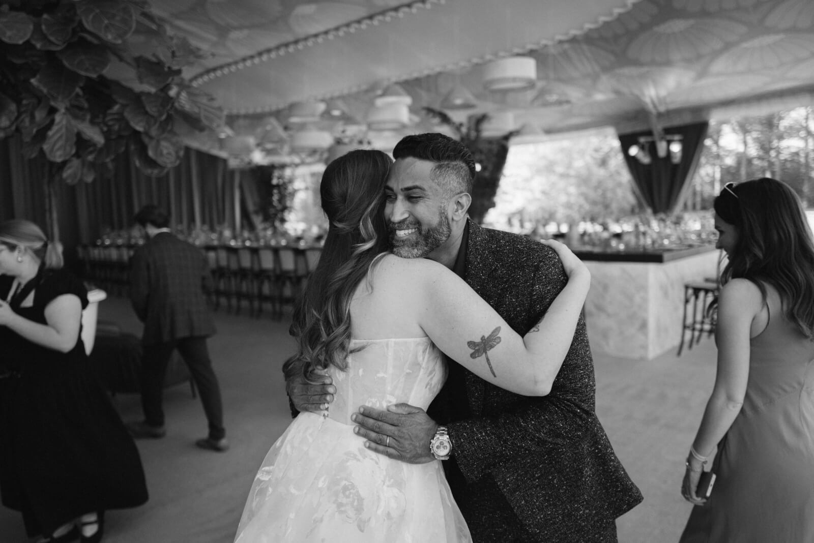The bride embraces HMR Designs' CEO Rishi Patel. 