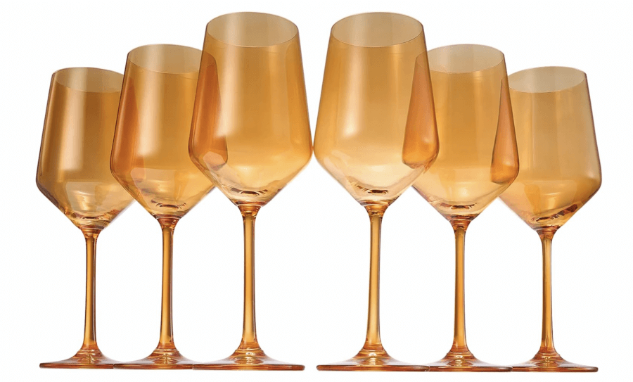 12 Colored Glass Accessories We Love: Cake Stands, Candlesticks & More - 8 Six elegant amber-colored wine glasses with tall stems are arranged in two rows, adding a touch of sophistication.