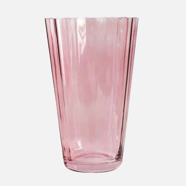 15 Memphis FINDS at Local Shops: Spring Dresses, Home Decor & More! - 16 A tall, clear pink glass tumbler with a slightly tapered shape and vertical ridges, featured in Memphis FINDS April, set against a plain white background.