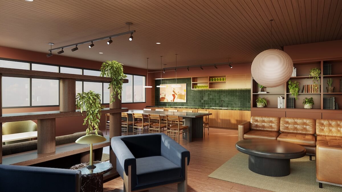 Modern open-concept living and dining area in one of the stunning homes for sale in East Nashville, featuring wooden floors, leather sofas, green accents, plants, bookshelves, and large windows letting in natural light.