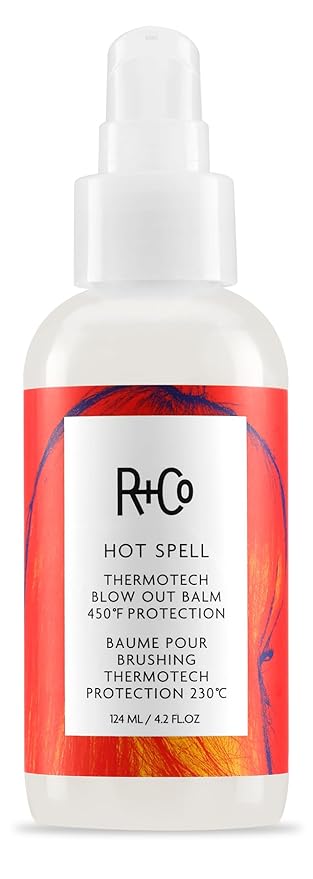 A white spray bottle of R+Co Hot Spell Thermotech Blow Out Balm, a standout in hair care with a red and orange label, offers 450°F (230°C) heat protection in a 124 ml (4.2 fl oz) size—highly rated in hair product reviews.