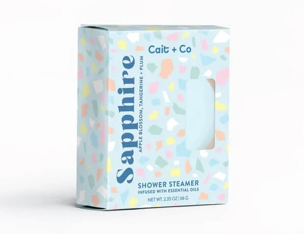 A box of Cait + Co Sapphire shower steamer featuring apple blossom, tangerine, and plum, with a colorful terrazzo pattern—perfect for Mother's Day or as unique grad gifts. Crafted in Nashville.