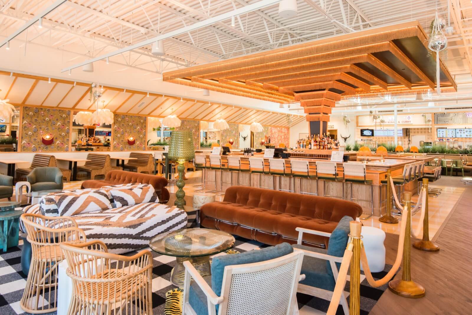 Georgia's 6 Best Girlfriends' Weekend Getaways - 15 A spacious, modern lounge with patterned sofas, wicker chairs, a central bar with illuminated canopy, and bright ambient lighting.