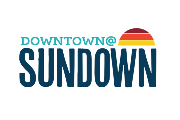 Logo with the words "Downtown At Sundown" in bold letters, plus a half-sunset graphic in red, orange, and yellow above "Sundown," capturing the vibrant spirit of this Summer Concert Series.