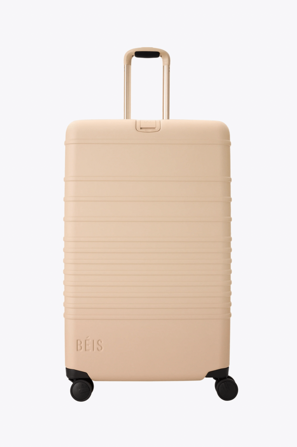 A beige hard-shell suitcase with four wheels, a telescopic handle, and the brand name "BÉIS" embossed on the lower corner—perfect for travel and a standout among the best luggage pieces.