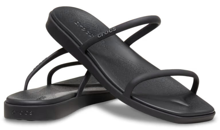 A pair of black Crocs sandals with two thin straps over the foot and a textured sole, featured on the SB Hot List for June 2025, displayed on a white background.