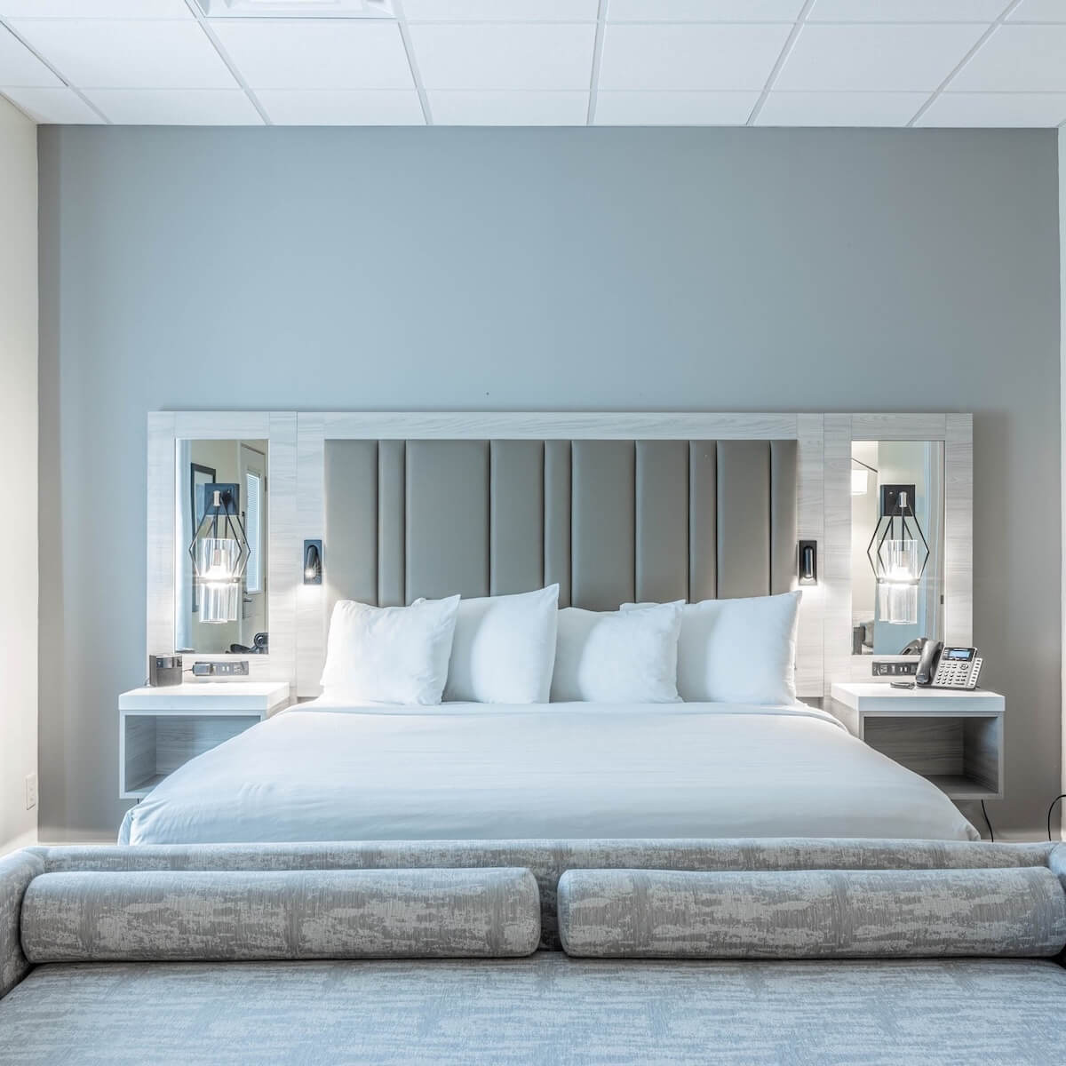 5 Charming Bed & Breakfasts in SC's Old 96 District - 2 Charming modern hotel room in the SC Old 96 District featuring a large bed with white linens, four pillows, two mirrored nightstands, and contemporary lamps—perfect for those who love stylish Bed & Breakfasts.