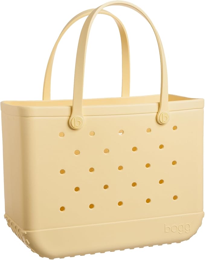 A beige, rectangular tote bag with two handles and small round holes on the sides—perfect for carrying your boating accessories. The bottom features subtle text that reads "bogg."