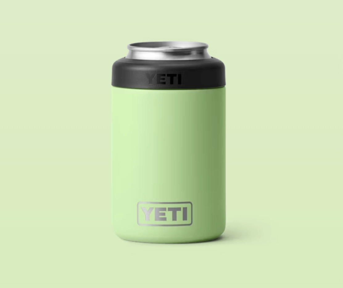A light green Yeti can insulator with a black top and the Yeti logo on the front, displayed against a matching light green background—an ideal addition to your boating accessories collection.