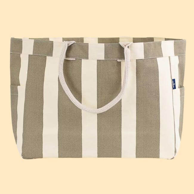 22 Birmingham FINDS for June: Breezy Dresses, Entertaining & Gifts for Dad - 11 Perfect for summer shopping, this beige and white striped canvas tote bag features sturdy rope handles and handy side pockets, displayed on a plain light beige background.