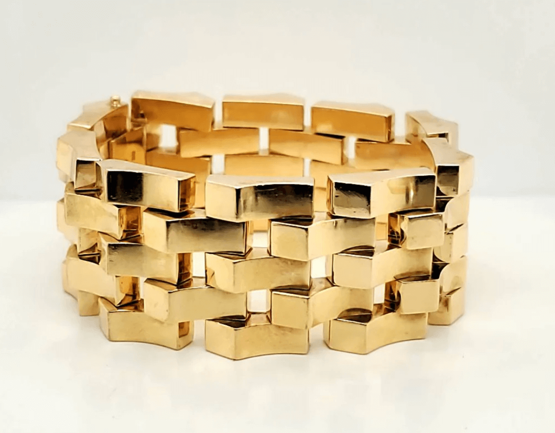 A chunky gold bracelet with interlocking rectangular links, displayed against a plain white background.