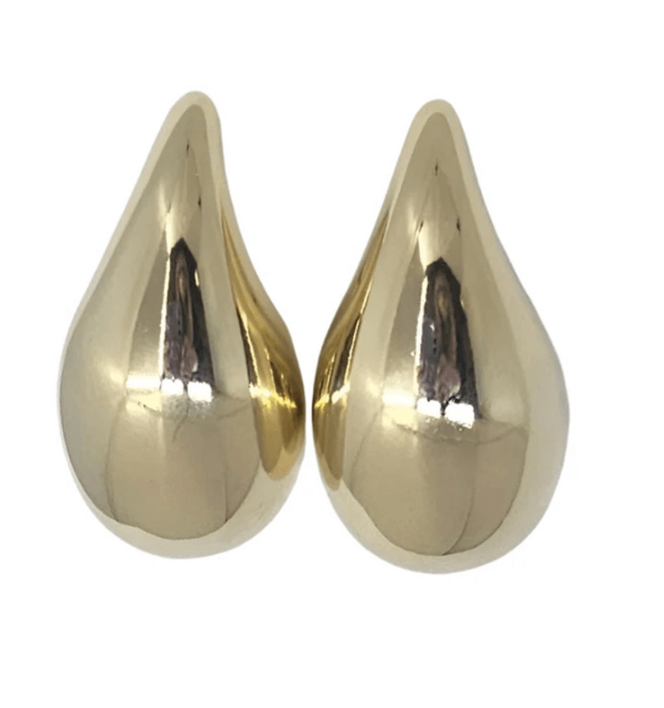 Two shiny, gold-colored, teardrop-shaped objects positioned side by side on a white background—an elegant June FINDS discovery from Birmingham.