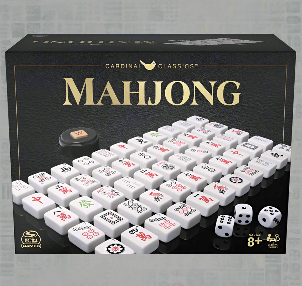 A boxed Cardinal Classics Mahjong set featuring white tiles with various symbols, two dice, and a wind indicator—perfect for game nights in Birmingham this June. Labeled for ages 8 and up.