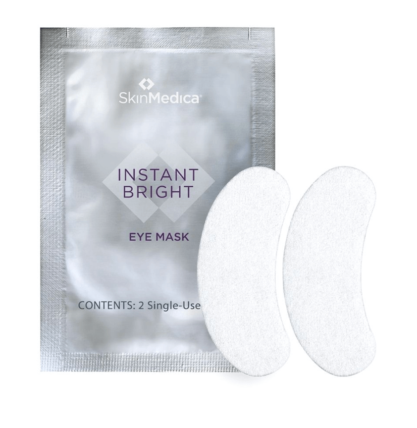 A silver packet labeled "SkinMedica Instant Bright Eye Mask" with two white crescent-shaped eye masks beside it—a June beauty FINDS favorite in Birmingham.