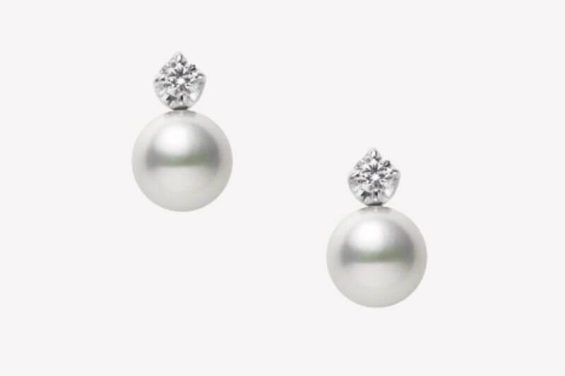 A pair of luxurious stud earrings featuring round white pearls with a single round diamond set above each pearl, perfect for adding elegance to any Memphis soirée in July 2025.