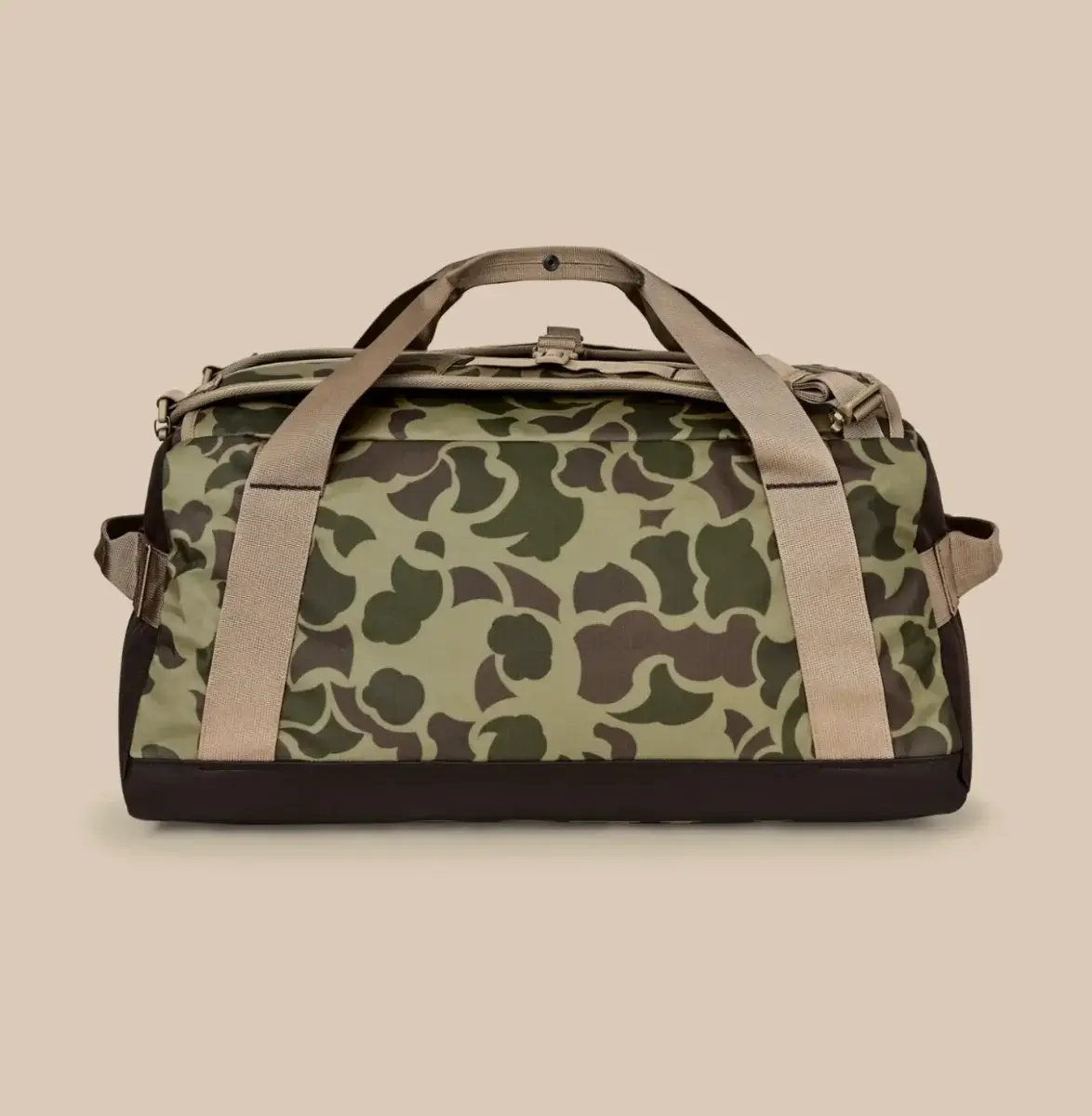 20 Nashville FINDS for June: Father's Day Gifts, Chic Accessories & More - 18 A green camouflage duffel bag with beige handles and a black base, perfect for shopping in Nashville, displayed on a plain beige background.