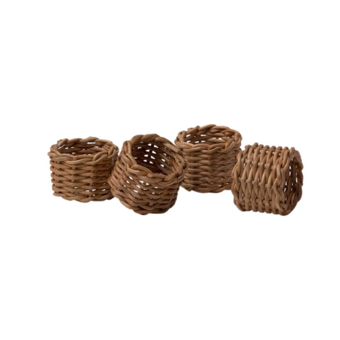 Four woven brown napkin rings are arranged in a row on a white background, perfect for adding a touch of Nashville charm to your June table settings and featured among our favorite FINDS.