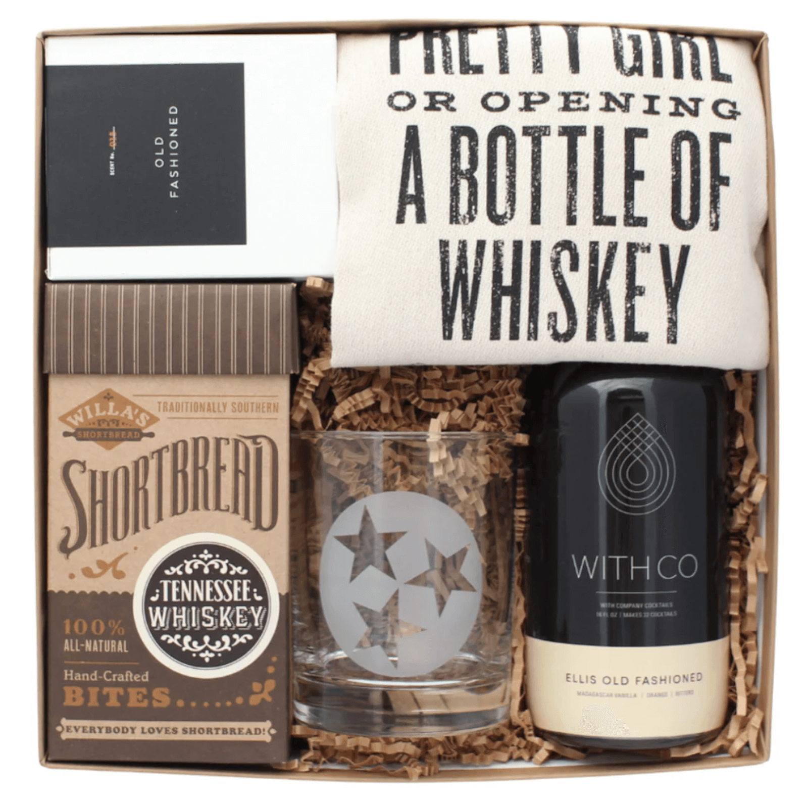 A Nashville-inspired gift box featuring a towel with text, a three-star glass, Tennessee whiskey shortbread bites, Ellis Old Fashioned mix, and a small black box—perfect for June celebrations or Southern FINDS.