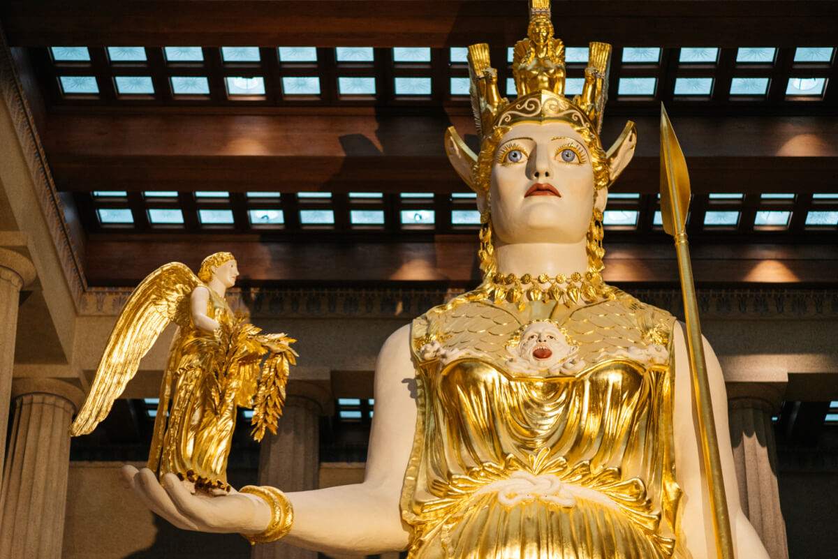 Meet Nashville's Own Golden Goddess: Athena Parthenos - 4 Inside Nashville’s Parthenon stands a large gold and ivory statue of Athena, holding a small winged figure beneath the building’s columns and coffered ceiling.