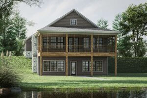 Two-story house with a large covered balcony, wooden railings, and stone chimney at 517 Transom Drive, featuring gray siding and situated by a pond surrounded by trees and grass near scenic Lake Martin.