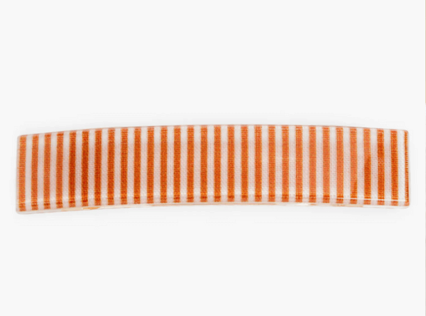 A rectangular ceramic tray featuring vertical cabana stripes in orange and white on a plain white background.