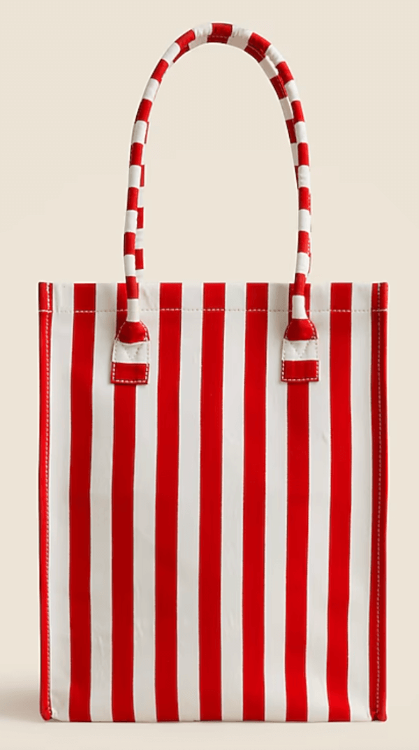 A tote bag with bold Cabana Stripes in red and white, featuring two matching striped handles, set against a plain background.