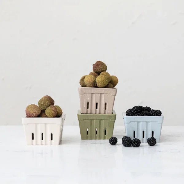 Three ceramic baskets filled with lychees and blackberries are arranged on a white surface against a plain, light-colored background, capturing the fresh flavors highlighted in Memphis FINDS.