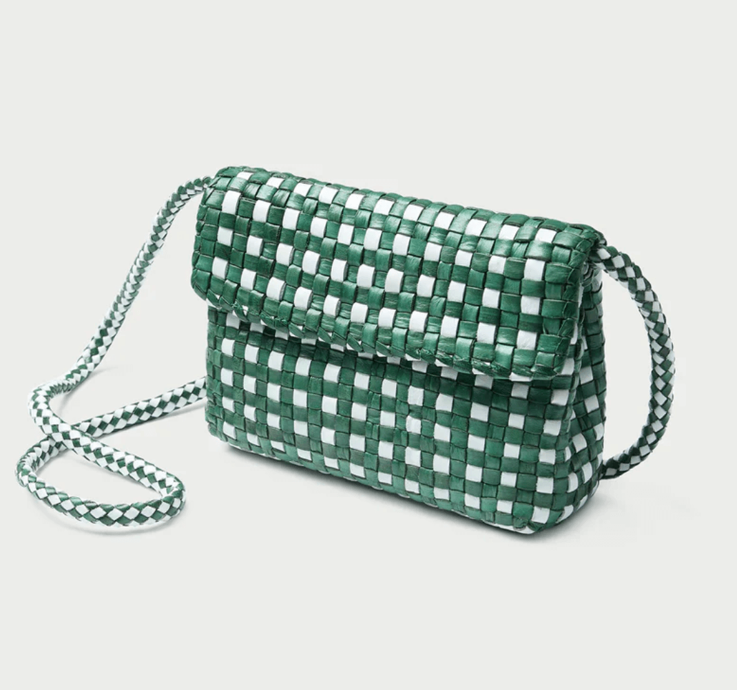 18 Nashville FINDS for Late Summer: Jewelry, Decor & More - 16 Green and white woven crossbody bag with a flap closure and braided shoulder strap, displayed against a plain light background—a perfect Nashville accessory among our Late Summer FINDS.