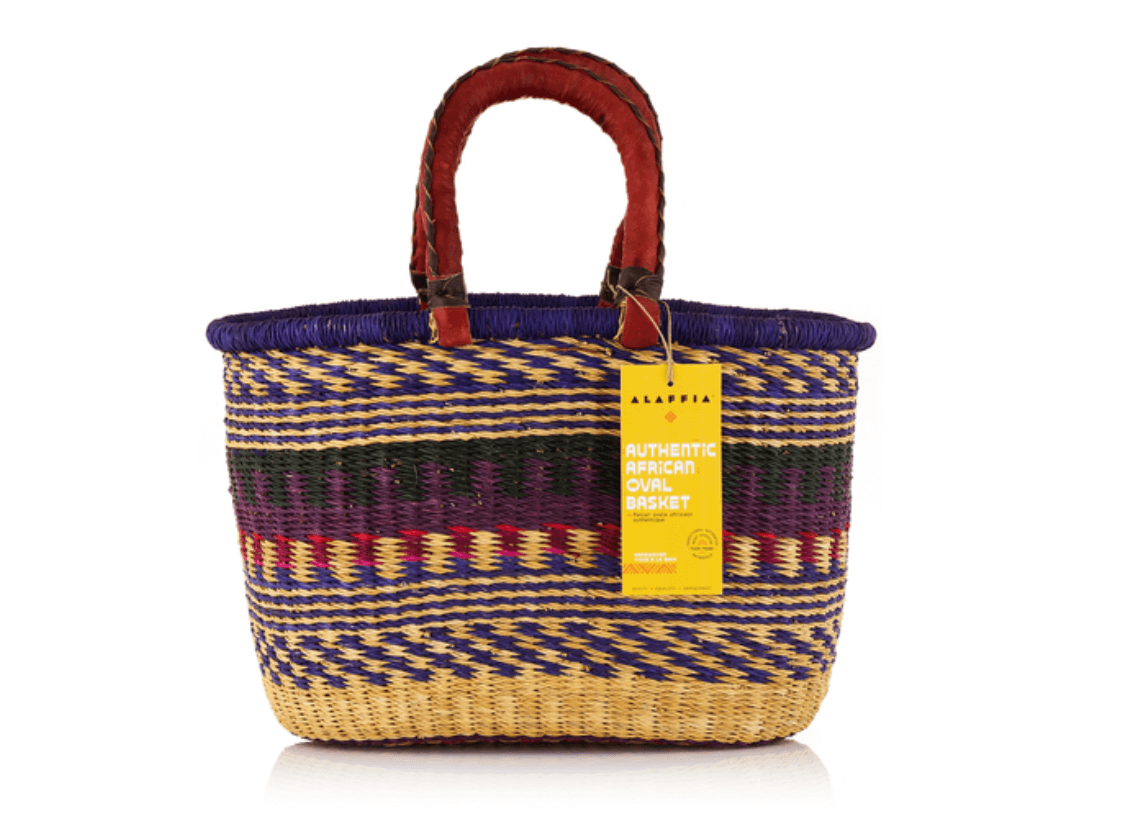 18 Nashville FINDS for Late Summer: Jewelry, Decor & More - 18 A woven oval basket with purple, yellow, and red patterns, two wrapped handles, and a yellow tag labeled "Authentic African Oval Basket," perfect for your Late Summer FINDS Nashville collection.