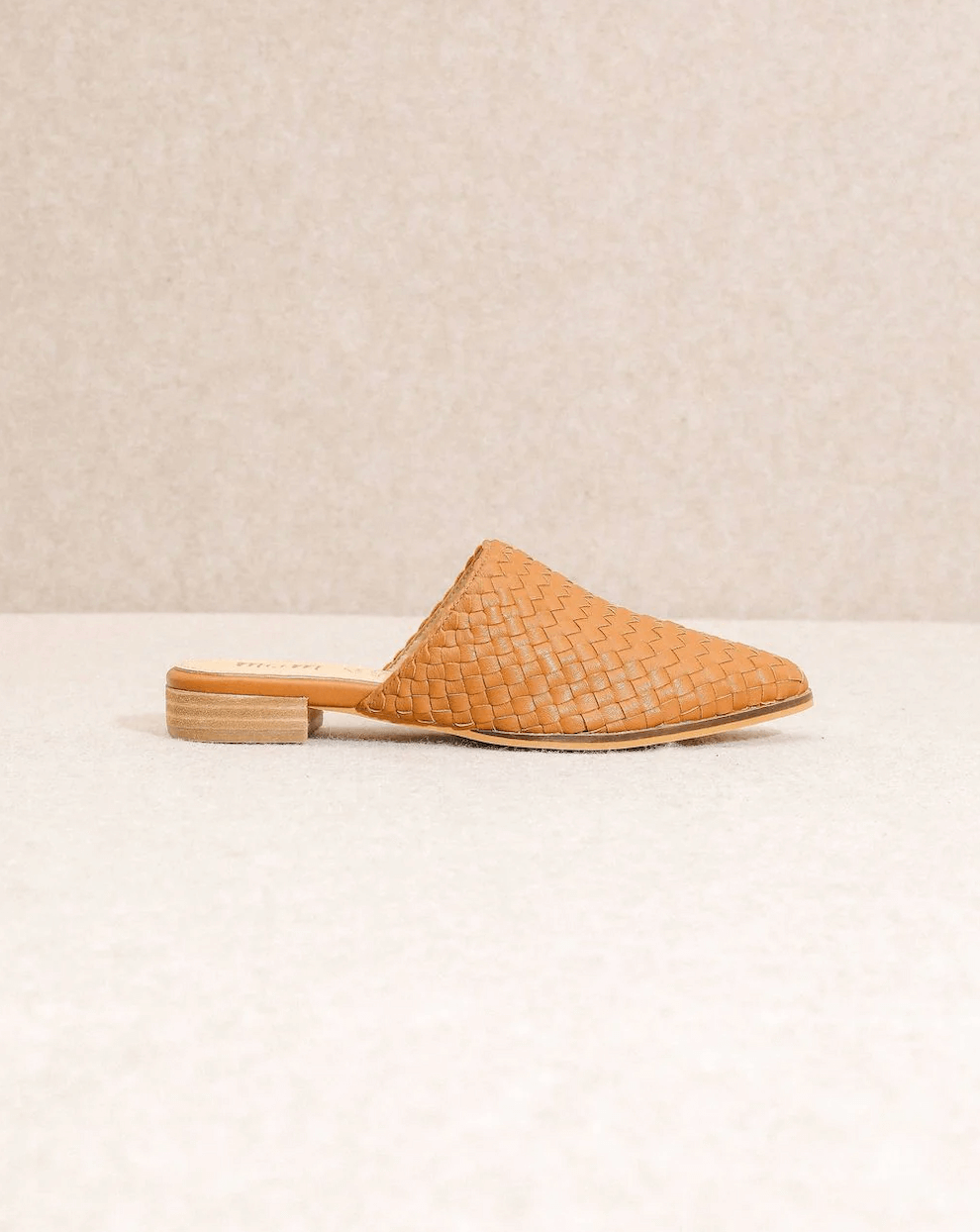 18 Nashville FINDS for Late Summer: Jewelry, Decor & More - 13 A tan woven mule shoe with a closed toe and low wooden heel, perfect for late summer style, displayed against a neutral background—an effortless pick from FINDS Nashville.