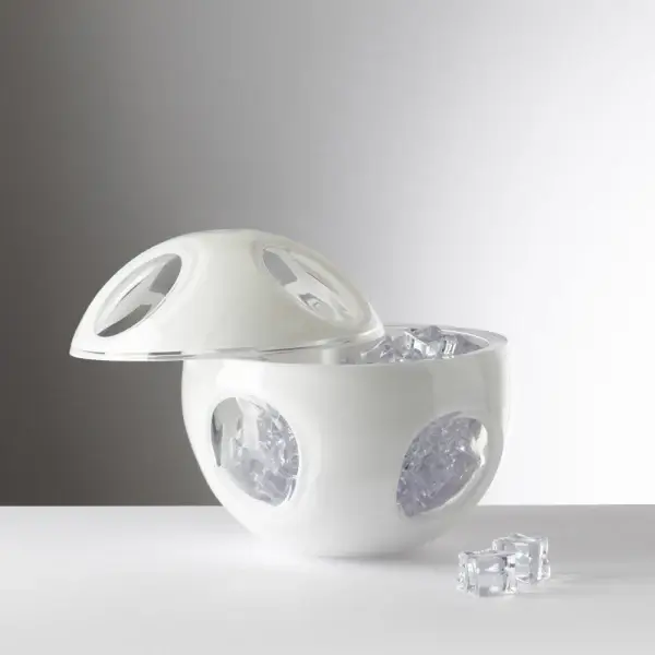18 Nashville Luxe Loves: Statement Jewelry, Custom Hats & Summer Showstoppers - 16 A white, spherical ice bucket with circular cutouts contains ice cubes, its lid resting slightly open and a few ice cubes placed outside.