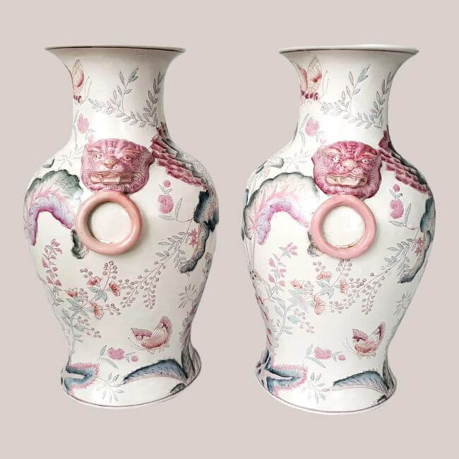 18 Nashville Luxe Loves: Statement Jewelry, Custom Hats & Summer Showstoppers - 15 Pair of decorative ceramic vases with floral patterns and pink lion head handles, each holding a ring in its mouth—a Nashville Luxe Loves accent for any stylish space.