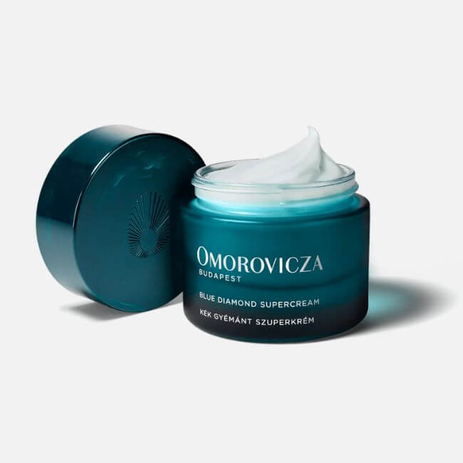 18 Nashville Luxe Loves: Statement Jewelry, Custom Hats & Summer Showstoppers - 13 A teal jar of Omorovicza Blue Diamond Supercream with the lid open, revealing white cream inside—a Nashville Luxe Loves favorite—set against a plain background.