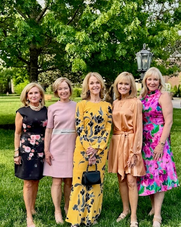 Southern Voices: My "Sex & The Symphony" Moment - 1 Five women stand outdoors on grass in front of a tree, dressed in colorful, formal dresses, smiling at the camera and celebrating the best decade of life.