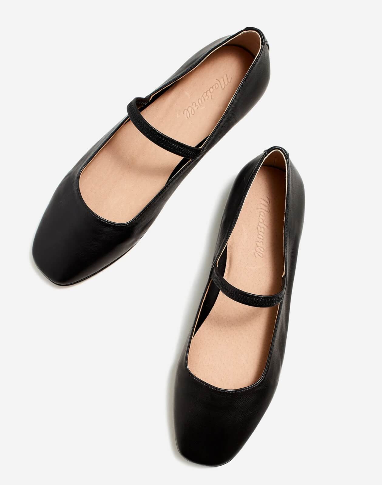 A pair of black Mary Jane flats with a single strap across the instep, displayed on a white background—so versatile, you'll want one in every color.