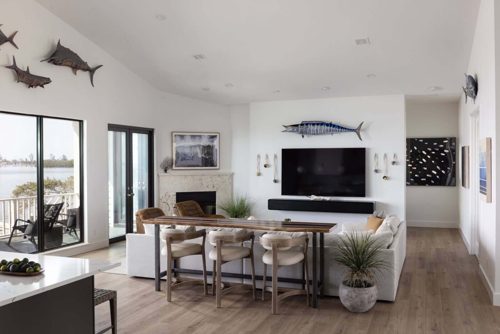 Look Inside This Effortlessly Chic Cape Haze Fishing Retreat - 4 A living room with a big-screen TV and mounted fish on the walls.
