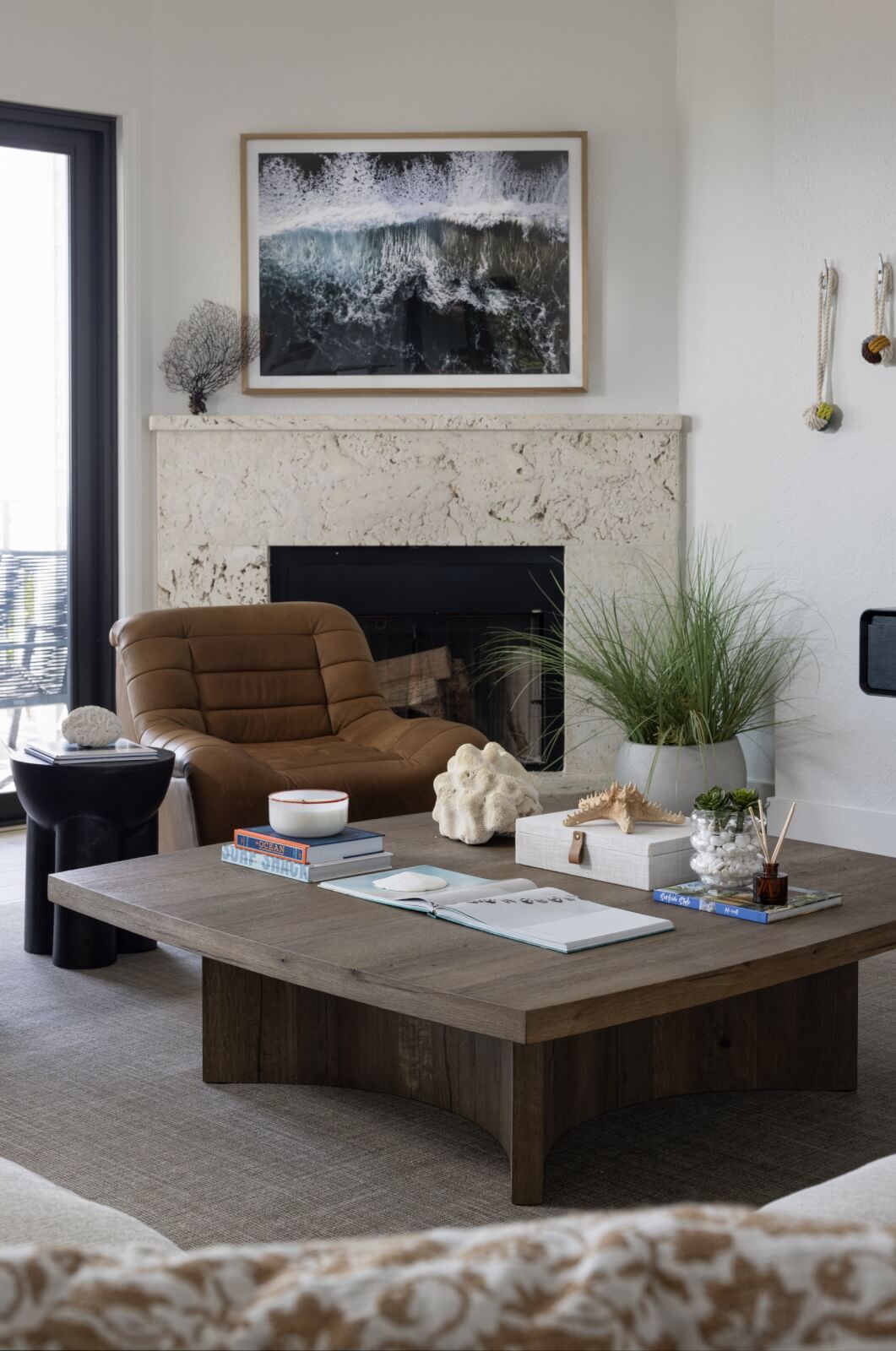 Look Inside This Effortlessly Chic Cape Haze Fishing Retreat - 3 A living room fireplace with a chair and coffee table.