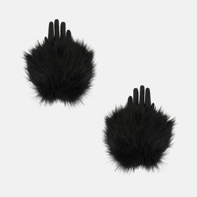 Fall 2025 Fashion: A Stylist's Lookbook of This Season's Trends - 35 A pair of black gloves with large, fluffy black fur on the back of the hands, reflecting Fall 2025 fashion trends, displayed on a plain light gray background.