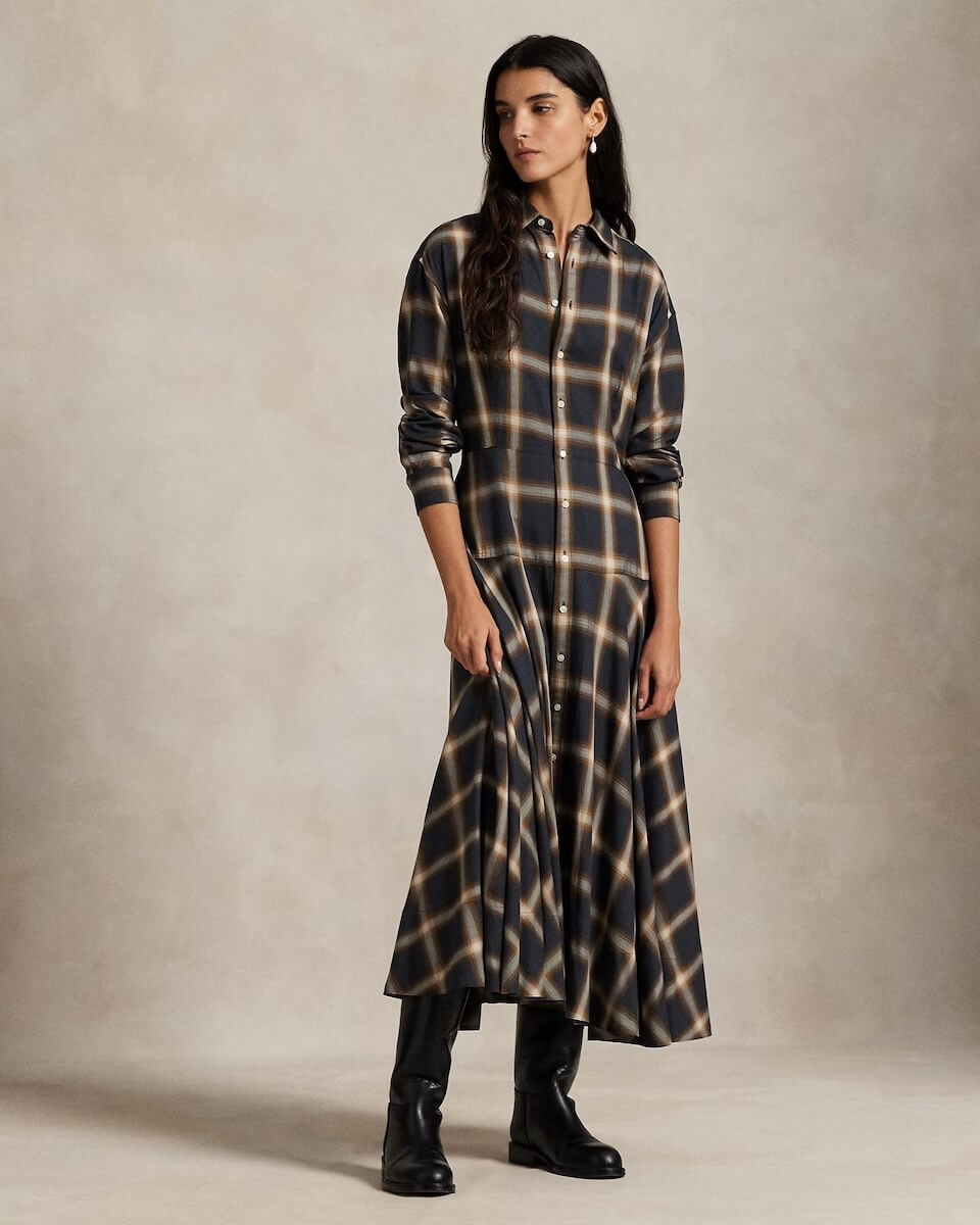 Fall 2025 Fashion: A Stylist's Lookbook of This Season's Trends - 79 Woman wearing a long-sleeve, ankle-length plaid dress with black boots, standing against a neutral background—capturing the essence of Fall 2025 fashion trends.