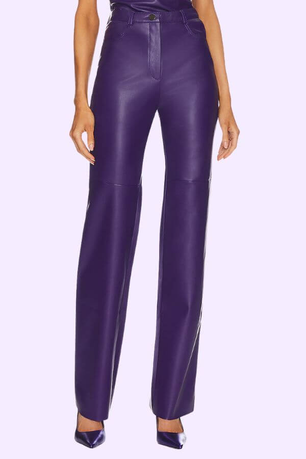 Fall 2025 Fashion: A Stylist's Lookbook of This Season's Trends - 44 A person wearing high-waisted, straight-leg purple leather pants and matching purple heels stands against a light background, capturing the bold spirit of Fall fashion and highlighting key fashion trends for Fall 2025.