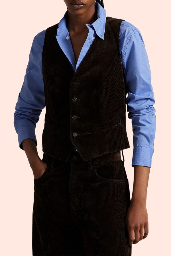 Fall 2025 Fashion: A Stylist's Lookbook of This Season's Trends - 64 Person wearing a blue button-up shirt under a dark brown corduroy vest and matching pants, with one hand in their pocket—a stylish nod to Fall 2025 Fashion Trends.