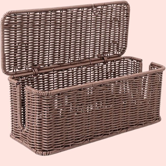 Rectangular brown wicker basket with a hinged lid, shown open against a light pink background—an elegant touch for storage and organization, featured on the SB Hot List for August 2025.