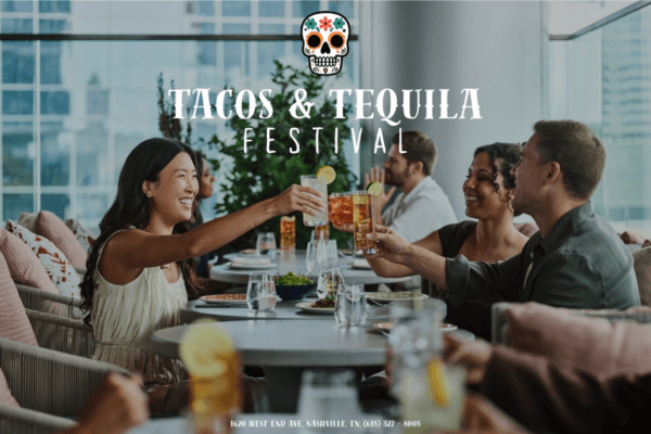 People seated around a restaurant table clinking glasses, with "Tacos & Tequila Festival" text and a decorative skull graphic overlaid, capturing the festive spirit of tacos and tequila.
