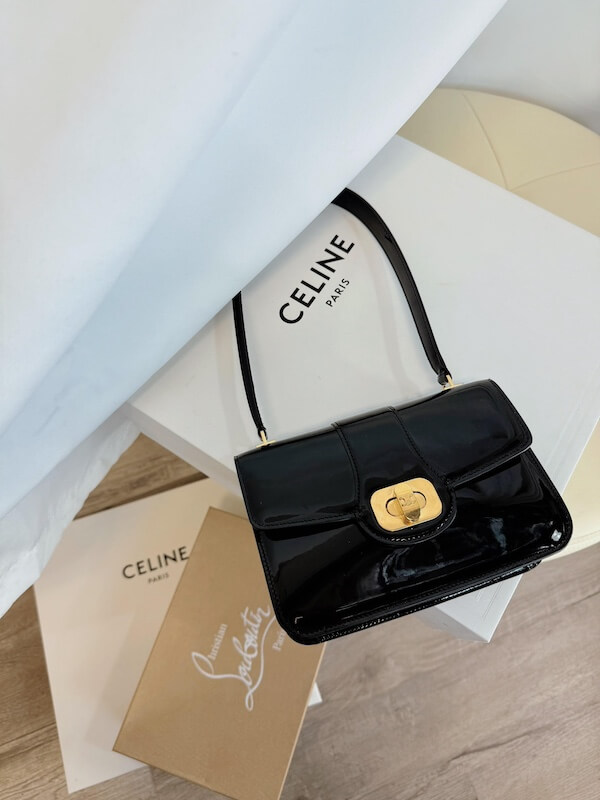 A black patent leather Celine handbag with a gold clasp rests on a white Celine box, next to a brown Celine envelope and a Christian Louboutin card—luxuries rarely seen in discount stores.