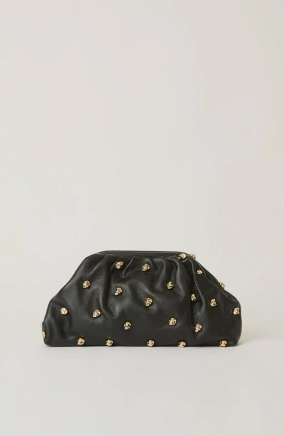 A black leather clutch purse with a ruched design and festive gold studs, perfect for November nights out in Nashville, displayed against a plain light background.