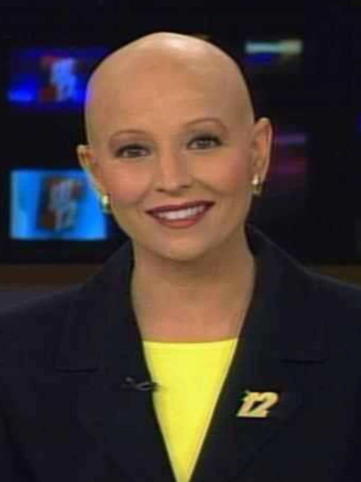 From the Newsroom to Morgan’s Wonderland: Leslie Mouton’s Story of Purpose - 3 Leslie Mouton at the anchor desk wearing yellow shirt and black blazer with bald head